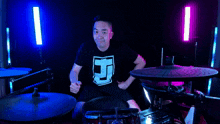 a man giving a thumbs up while playing a drum set