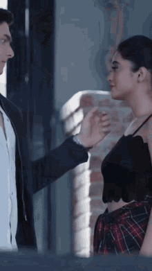 a man and a woman are looking at each other