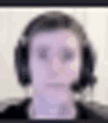 a blurry picture of a man wearing headphones and a headset .