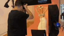 a man is taking a picture of a woman with a broncolor softbox