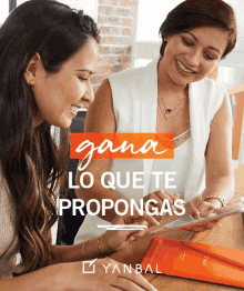 two women are smiling and looking at a tablet with the words " gana lo que te propongas " above them