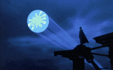 a man in a cape stands on top of a building in front of a blue moon with a yellow splat on it