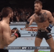 two men are fighting each other in a boxing match .