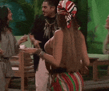 a woman wearing glasses and a head scarf is dancing with another woman