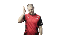 a man wearing a red shirt with the letter g on the front