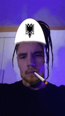 a man with a beard wearing a white hat with an eagle on it