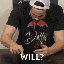 a man wearing a black shirt that says dallas is pointing at something
