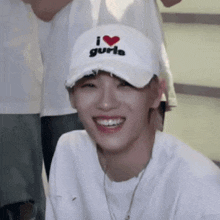 a young man wearing a white hat that says i love gurls