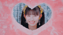 a girl is smiling in a heart shaped hole