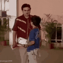 a man and a boy are standing next to each other .
