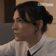 a close up of a woman 's face with the word countdown on the bottom right