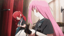 a girl with pink hair is playing a guitar next to another girl