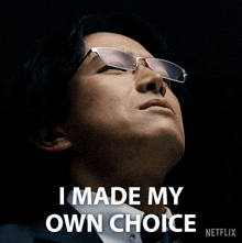 a man wearing glasses and a suit says " i made my own choice "