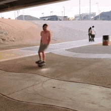 a man is riding a skateboard on a concrete surface under a bridge