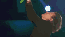 a person is brushing their teeth in a dark room with a light on their head .