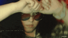 a person wearing sunglasses and a shirt that says gang 1690