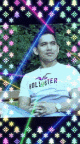 a man wearing a hollister shirt is surrounded by colorful lights