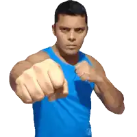 a man in a blue tank top with his fist up