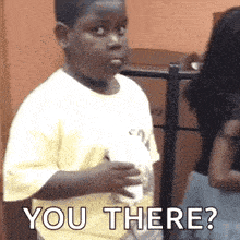a young boy is holding a cup of coffee and asking , `` you there ? '' .