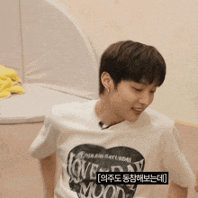 a person wearing a white shirt that says love saturday moon