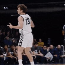 a basketball player with the number 13 on his jersey