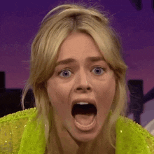 a close up of a woman with her mouth wide open
