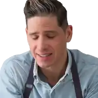 a man wearing an apron and a blue shirt is making a funny face
