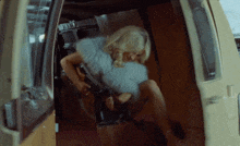 a woman in a fur coat is sitting in the back of a van