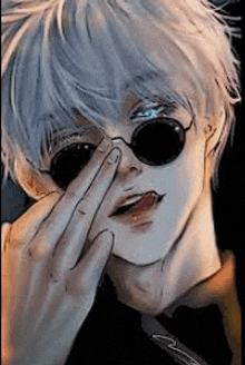 a close up of a person wearing sunglasses covering their face .