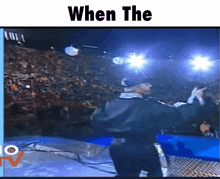 a man in a black jacket is standing in front of a crowd with the words " when the " on the bottom