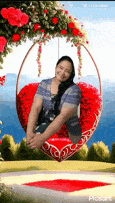 a woman is sitting on a heart shaped swing surrounded by roses