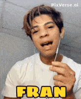a man wearing ear buds and a white shirt with the name fran on it