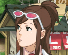 a girl wearing sunglasses is standing in front of a sign that says l