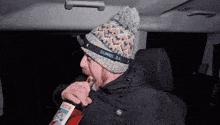 a man wearing a sunglasa headlamp holds a bottle of austin