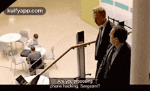 two men are standing on a set of stairs talking to each other .