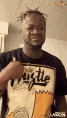 a man wearing a hustle t-shirt is making a funny face
