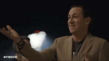 a man in a suit and lanyard says that 's the guy