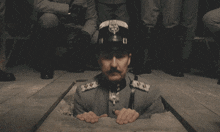 a man in a military uniform with the letter d on his hat
