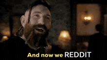 a man with a beard says " and now we reddit " in a black and white photo