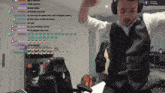 a man wearing headphones and a vest is dancing in front of a screen that says in the city