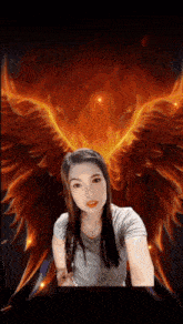 a woman taking a selfie in front of a painting of a phoenix