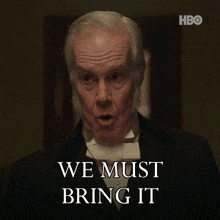 a man in a tuxedo with the words we must bring it