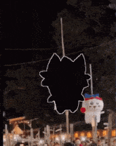 a black and white drawing of a pig hanging from a string