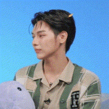 a young man is holding a stuffed animal in his hands .