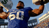 a football player wearing a byu jersey holds up a bag