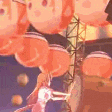 a bunch of orange balloons hanging from a tower