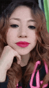 a close up of a woman 's face with a pink lip