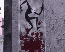 a drawing of a monster on a wall with bloody hand prints