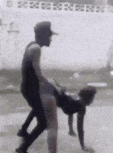 a man is carrying a woman on his back .