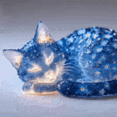 a blue cat sleeping with its eyes closed and covered in blue flowers
